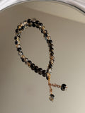 Noor Tesbih in schwarz mit goldenen Details